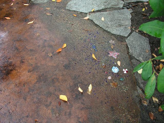 A concrete patio with exposed aggregate art.